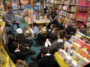 Kieran reads with the boys and girls from Dominican Convent Primary School